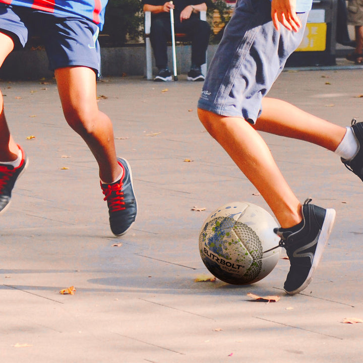 Kids in a square playing with the BlitzBolt soccer ball.